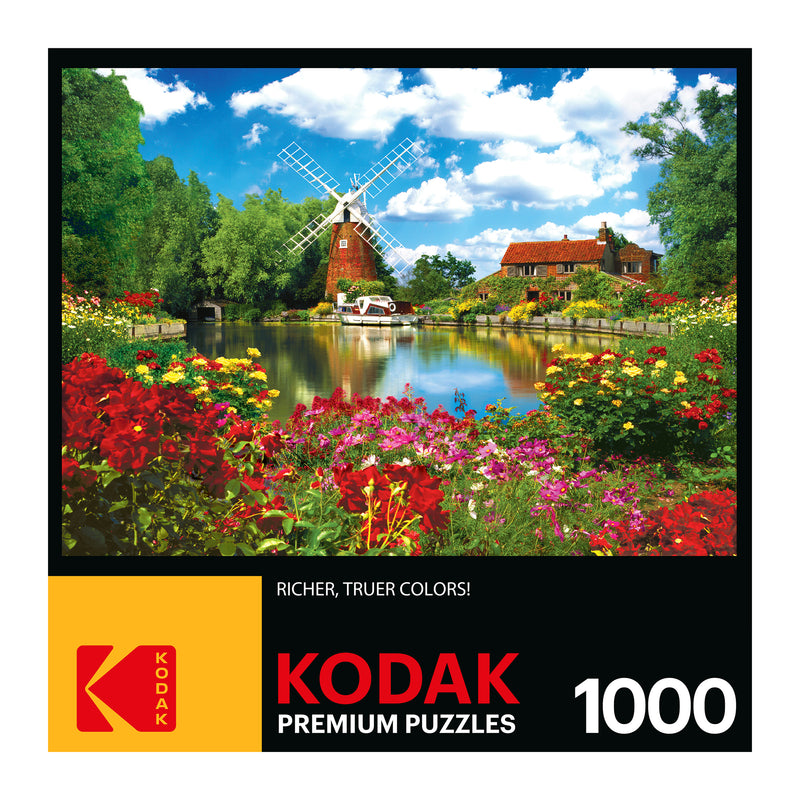 A box of RoseArt - Kodak Premium - Hunsett Mill and the River Ant, Norfolk, England - 1000 Piece Jigsaw Puzzle, featuring a colorful garden scene with flowers, a windmill, and a house by a pond. The puzzle has 1000 pieces.