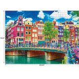 A RoseArt - Kodak Premium - Colorful Waterfront Buildings, Amsterdam - 1000 Piece Jigsaw Puzzle depicting a colorful row of buildings along a canal in Amsterdam, with a bridge in the foreground.