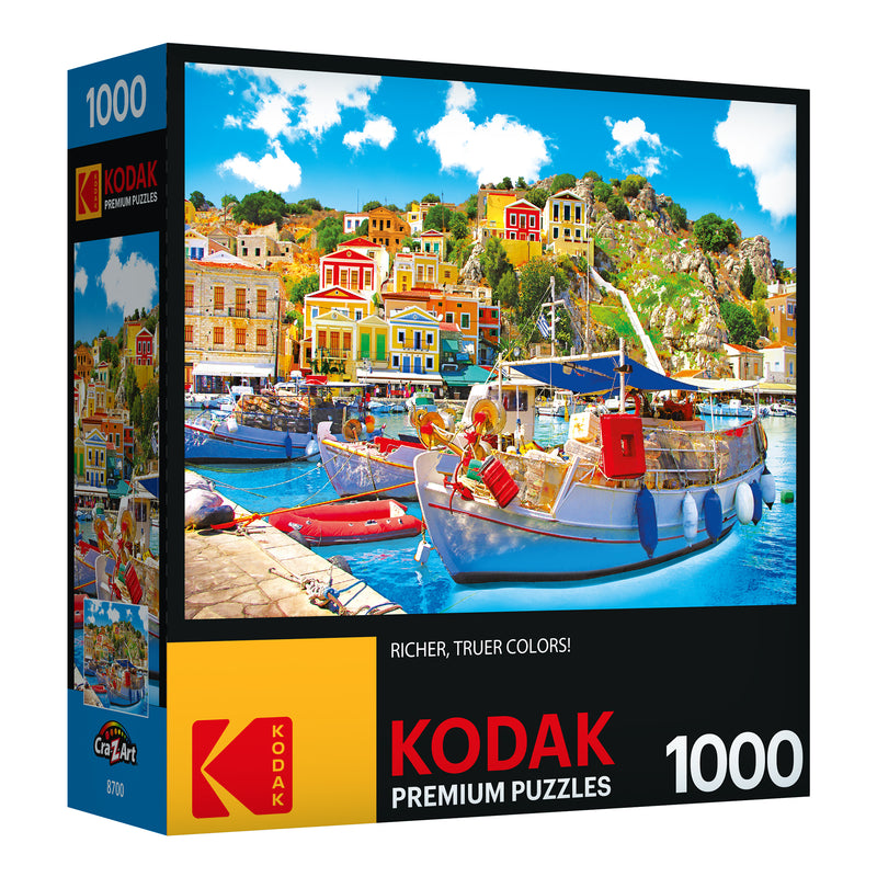 RoseArt - Kodak Premium - Symi with Boats in the Harbor, Greece - 1000 Piece Jigsaw Puzzle box showing a colorful seaside village scene with boats docked in the harbor. The puzzle is 1000 pieces.
