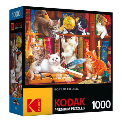 A 1000-piece RoseArt - Kodak Premium - Library Mischief - 1000 Piece Jigsaw Puzzle featuring an image of playful kittens on a bookshelf with old books and a pair of glasses.