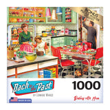 A RoseArt - Back to the Past - Baking with Mom - 1000 Piece Jigsaw Puzzle showing a vintage-style kitchen scene with a woman and two children. The box text reads "Back to the Past" and "Baking with Mom." The puzzle has 1000 pieces and includes a bonus poster.