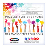 A vibrant background shows diverse skin-toned arms holding puzzle pieces, with "Puzzles for Everyone" in English and French. Jigsaw fans will appreciate the detail. Social media icons and RoseArt's logo, enhanced by Bigelow Illustrations' unique touch, stand below the Lemonade on the Lawn puzzle name.