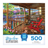 Box cover of the ROSEART - BIGELOW ILLUSTRATIONS - PORCH LIFE 500-piece jigsaw puzzle showing a vibrant scene: cozy porch, dog, rocking chair, plants, with a tranquil lake and mountain view.