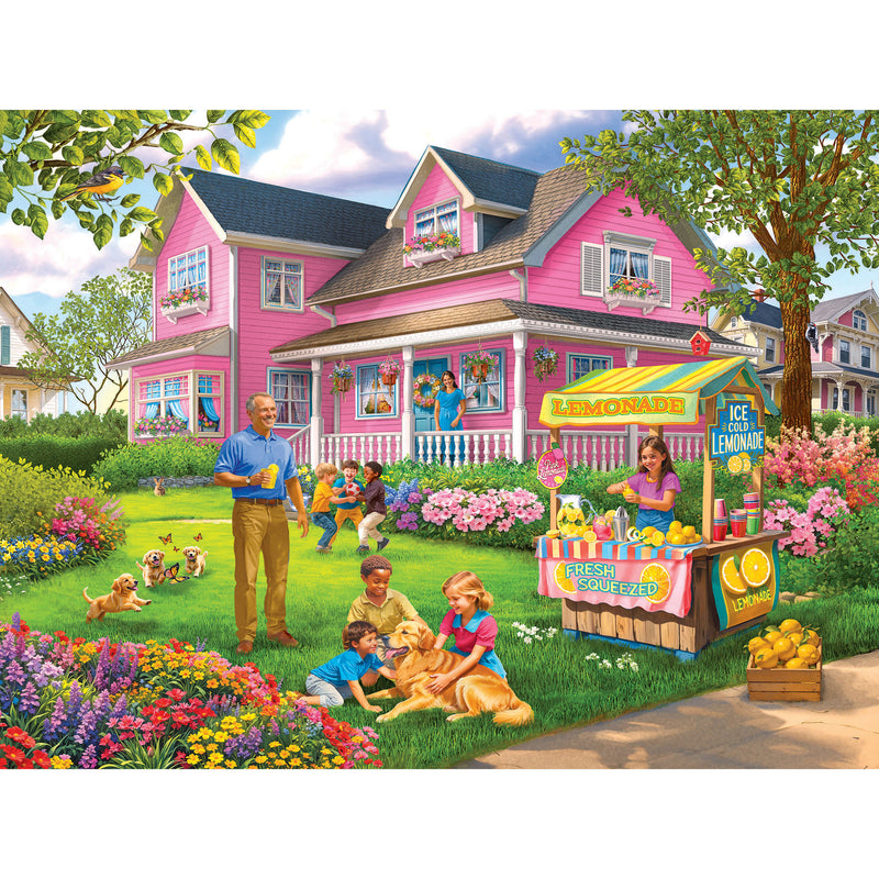 The ROSEART - BIGELOW ILLUSTRATIONS - LEMONADE ON THE LAWN - 500 PIECE JIGSAW PUZZLE showcases a pink house surrounded by flowers, with joyful adults and children at a lemonade stand, kids on the grass, and a charming scene perfect for both young and old.