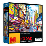 A box of RoseArt - Kodak Premium - Times Square & 7th Avenue, Manhattan, NY - 1000 Piece Jigsaw Puzzle featuring a 1000-piece puzzle with a vibrant city street scene, focusing on colorful signs and billboards.