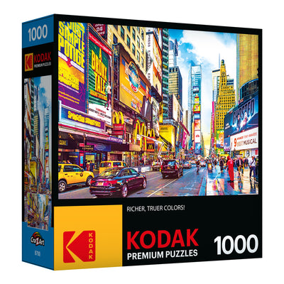 A box of RoseArt - Kodak Premium - Times Square & 7th Avenue, Manhattan, NY - 1000 Piece Jigsaw Puzzle featuring a 1000-piece puzzle with a vibrant city street scene, focusing on colorful signs and billboards.