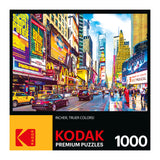 A colorful image of Times Square in New York City, featuring vibrant billboards, busy streets, and numerous pedestrians, on the box cover of a RoseArt - Kodak Premium - Times Square & 7th Avenue, Manhattan, NY - 1000 Piece Jigsaw Puzzle.