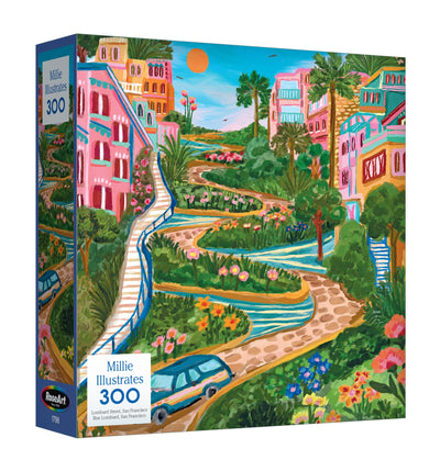 Discover the ROSEART - MILLIE ILLUSTRATES 300 Piece Jigsaw Puzzle featuring Lombard Street, San Francisco. The box showcases vibrant buildings, lush greenery, and a bright sky, capturing the street’s iconic charm.
