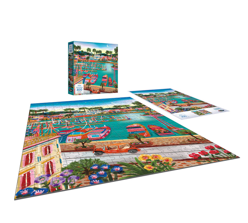 The ROSEART Millie Illustrates 300-piece jigsaw puzzle showcases a vibrant Vieux Port de Cannes harbor scene with boats and flowers, complete with a box and image guide.