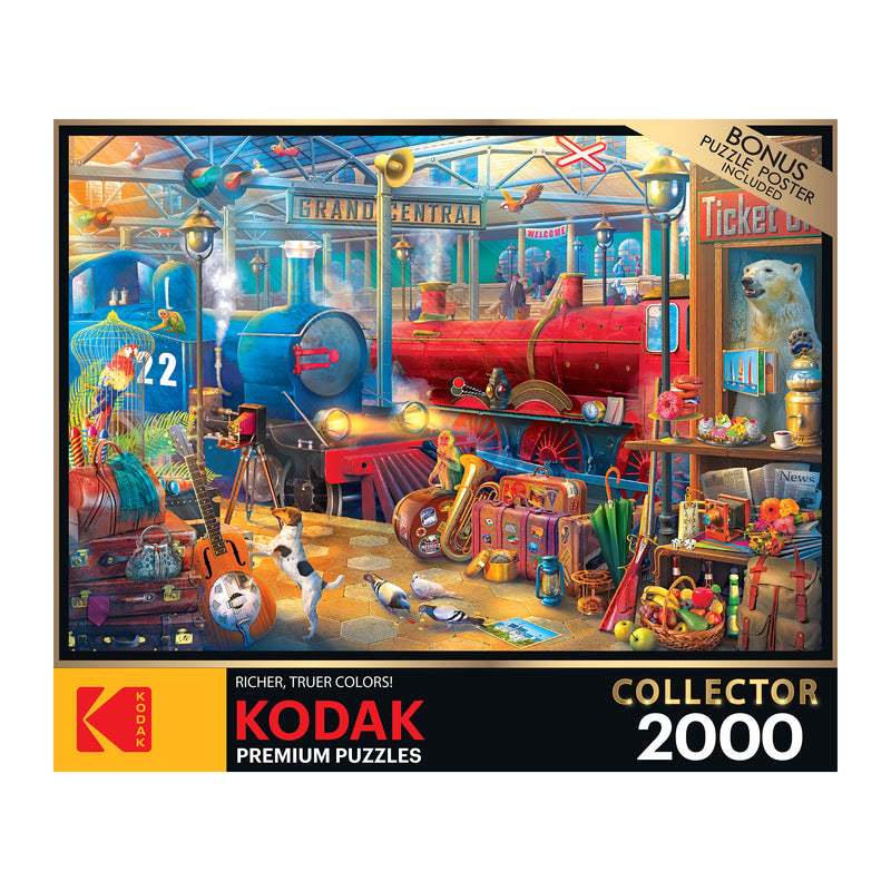 A 2000-piece RoseArt - Kodak Collector - Train Station - 2000 Piece Jigsaw Puzzle featuring a busy train station scene with animals, toys, and colorful details. The box mentions Kodak premium puzzles with richer, truer colors.