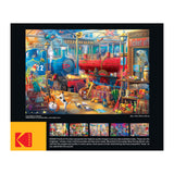 Colorful box showing a RoseArt - Kodak Collector - Train Station - 2000 Piece Jigsaw Puzzle of a vibrant, detailed toy workshop scene with various tools, trains, and toys, with smaller images and a product description below.