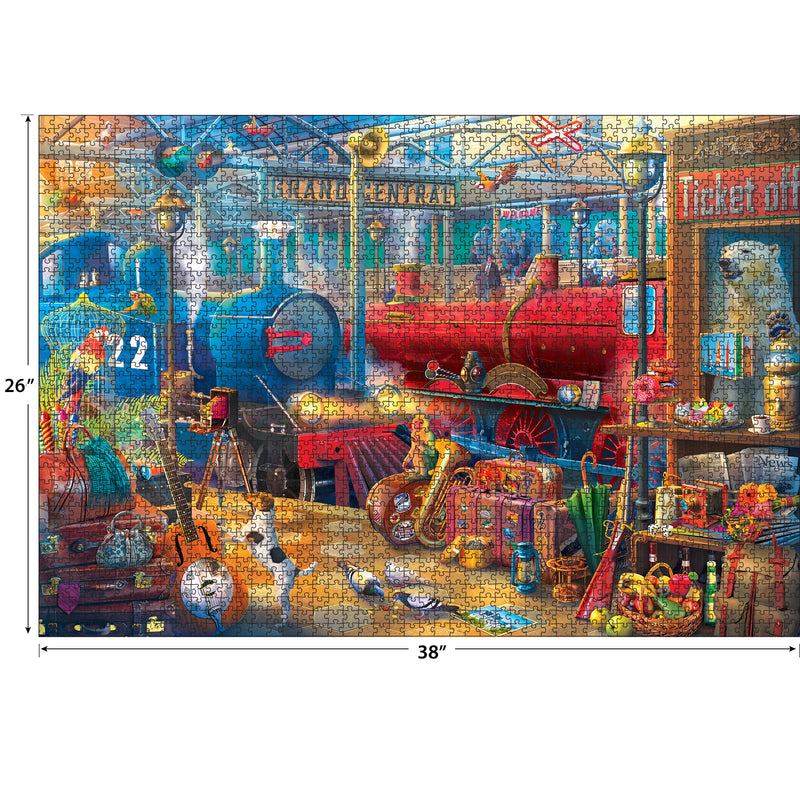 Colorful image of a cluttered vintage train station scene, featuring a red and blue train, luggage, musical instruments, and various artifacts. Dimensions are labeled: 26 inches tall by 38 inches wide. Product Name: RoseArt - Kodak Collector - Train Station - 2000 Piece Jigsaw Puzzle