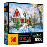 Box of a RoseArt - Kodak Premium - Christmas at Home - 1000 Piece Jigsaw Puzzle featuring a snowy holiday scene with a red house, decorated tree, lamppost, and a fence.