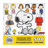 A 500-piece RoseArt - Peanuts 12 Multi-Shaped - Peanuts - 500 Piece Jigsaw Puzzle set showing various characters, with Snoopy in the center. The box showcases cartoon images of characters like Charlie Brown and Lucy, with a bonus puzzle poster included.