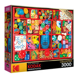 Image of a RoseArt - Kodak Premium - Vintage Toy Box - 3000 Piece Jigsaw Puzzle box, featuring a colorful assortment of small toys, dice, and trinkets. The box also mentions a bonus puzzle poster.