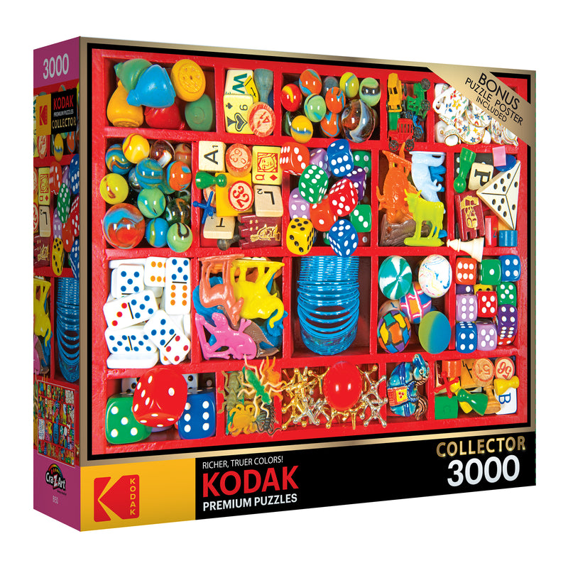 Image of a RoseArt - Kodak Premium - Vintage Toy Box - 3000 Piece Jigsaw Puzzle box, featuring a colorful assortment of small toys, dice, and trinkets. The box also mentions a bonus puzzle poster.