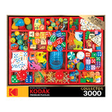 A 3000-piece RoseArt - Kodak Premium - Vintage Toy Box - 3000 Piece Jigsaw Puzzle titled "Collector," depicting an assortment of colorful toys, dice, and small objects organized in a red compartmentalized tray. Bonus puzzle poster included.