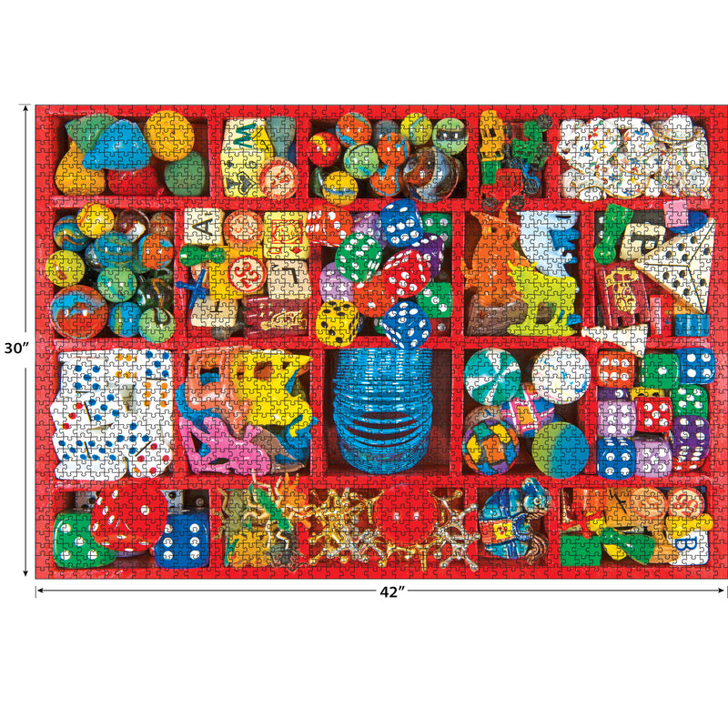 A completed RoseArt - Kodak Premium - Vintage Toy Box - 3000 Piece Jigsaw Puzzle measuring 42 inches by 30 inches features an assortment of colorful small items including dice, toys, balls, and puzzles organized in a red-bordered grid.