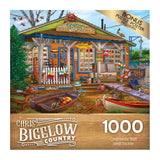 RoseArt - Chris Bigelow - Castaway Bait and Tackle - 1000 Piece Jigsaw Puzzle showing a charming lakeside bait and tackle shop with a boat dock, colorful signs, and fishing gear displayed. The puzzle contains 1000 pieces and includes a bonus poster.