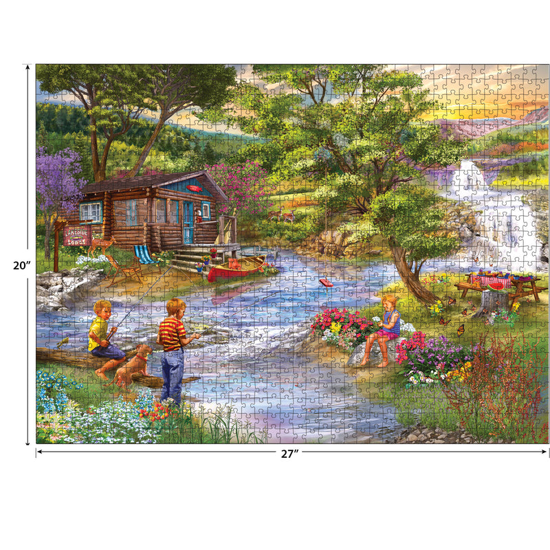 A completed RoseArt - Chris Bigelow - Fishing from the Banks - 1000 Piece Jigsaw Puzzle depicting a tranquil scene with children playing and fishing by a stream near a cottage, surrounded by trees and flowers. The puzzle measures 20 inches by 27 inches.