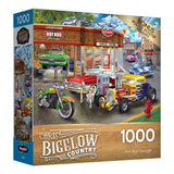 A RoseArt - Chris Bigelow - Hot Rod Garage - 1000 Piece Jigsaw Puzzle titled "Hot Rod Garage" by Chris Bigelow, showing a vibrant scene with vintage cars, motorcycles, and a gas station. The box features a bonus poster of the puzzle image.