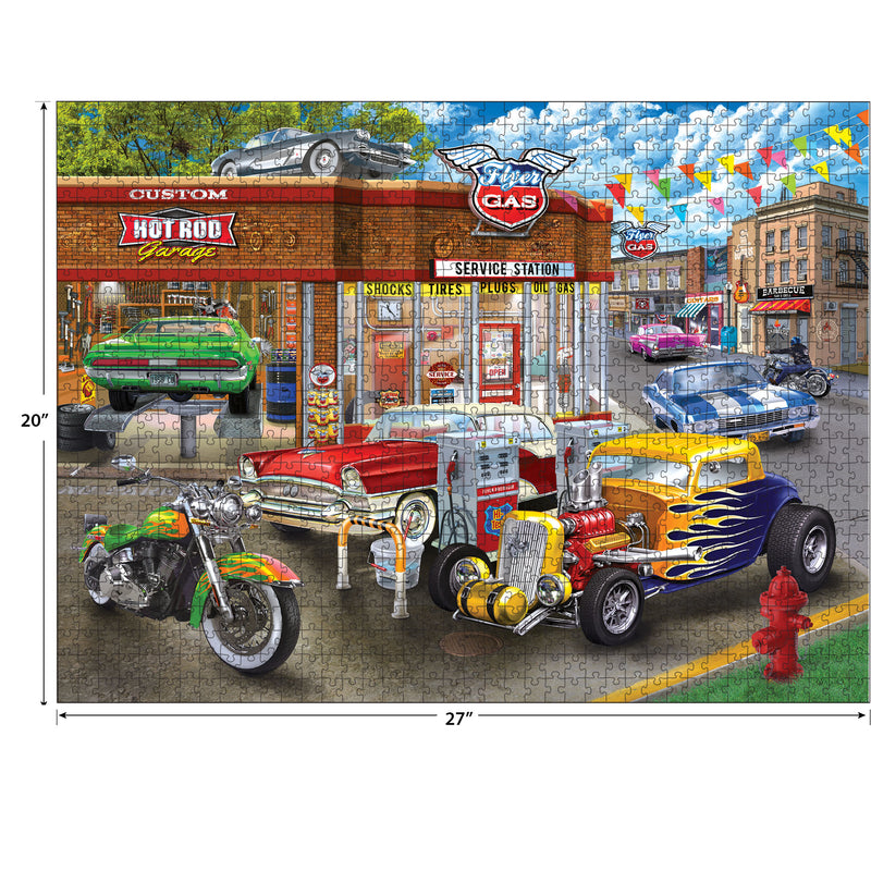 A colorful jigsaw puzzle, RoseArt - Chris Bigelow - Hot Rod Garage - 1000 Piece Jigsaw Puzzle, depicts a lively street scene featuring classic cars, a vintage gas station, and a custom hot rod shop. A mix of red, yellow, green, and blue cars is parked around the area.
