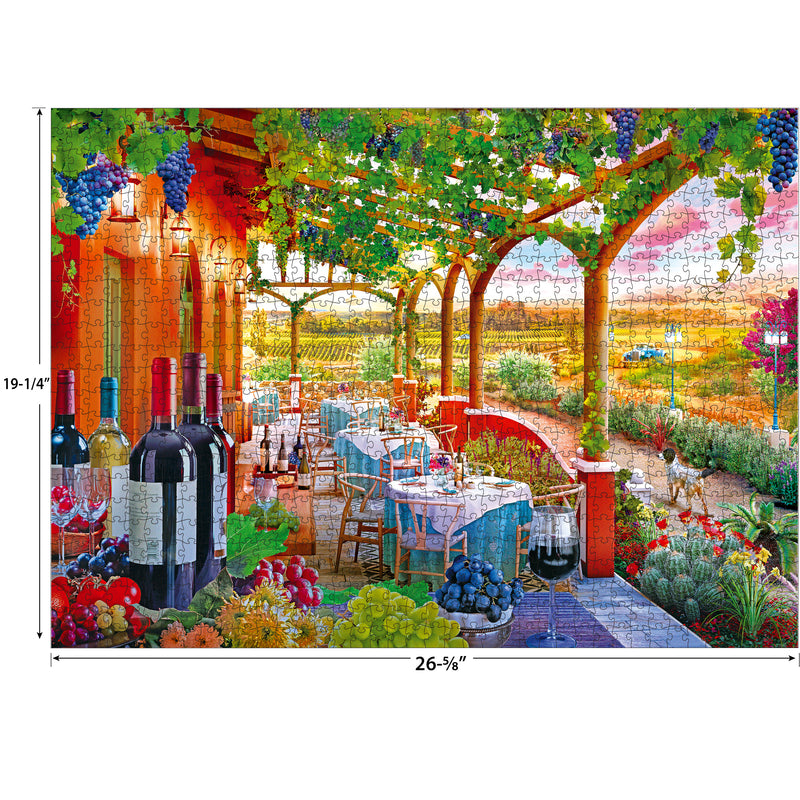 RoseArt - Kodak Cork - Wine Country - 1000 Piece Jigsaw Puzzle depicting an outdoor dining scene with a vineyard view. Tables are set with wine bottles and glasses under a pergola with hanging grapevines. Dimensions are 26.75 by 19.25 inches.