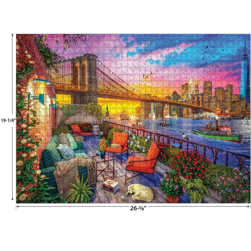 A completed RoseArt - Kodak Cork - Manhattan Balcony Sunset - 1000 Piece Jigsaw Puzzle depicting a sunset view of the Brooklyn Bridge, skyscrapers, and waterfront, with a cozy patio furnished with chairs, flowers, and a small dog. Dimensions: 26-5/8" x 19-1/4".