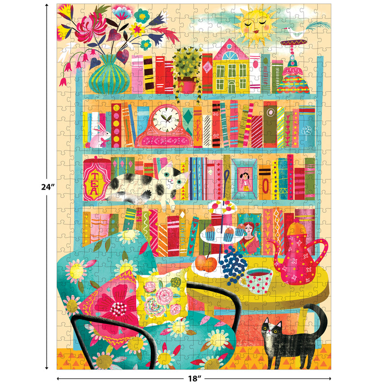 The ROSEART - VERTICAL VISIONS - Bookshelf with Cats 500 PIECE JIGSAW PUZZLE features a colorful, cozy room scene with cats, books, and charming décor; includes 500 pieces and measures 24" x 18".