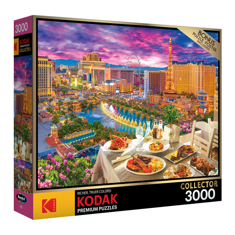Box for a RoseArt - Kodak Premium - La Vida Las Vegas - 3000 Piece Jigsaw Puzzle featuring a colorful, detailed image of a Las Vegas skyline with a table of food in the foreground.