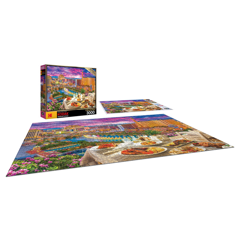 A completed RoseArt - Kodak Premium - La Vida Las Vegas - 3000 Piece Jigsaw Puzzle with an image of an outdoor dining scene. The puzzle box and another puzzle are shown in the background.