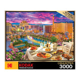 RoseArt - Kodak Premium - La Vida Las Vegas - 3000 Piece Jigsaw Puzzle box depicting a vibrant Las Vegas skyline at dusk with an outdoor dining scene in the foreground. Includes a bonus puzzle poster.