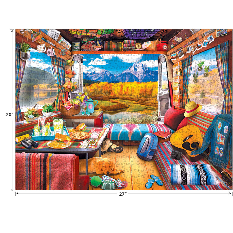 Illustration of a cozy van interior with a vibrant mix of colorful blankets, pillows, and decorations, featuring a scenic mountain view visible through the rear doors. Measurement dimensions are 20"x 27". Product Name: RoseArt - My Happy Place - Van Life, The Grand Tetons - 750 Piece Jigsaw Puzzle