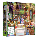 A boxed 750-piece jigsaw puzzle featuring a vibrant café scene with people eating, talking, and working. The puzzle includes a bonus poster and is titled "RoseArt - My Happy Place - The Neighborhood Cafe - 750 Piece Jigsaw Puzzle.