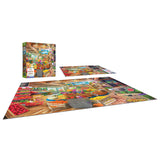 A completed jigsaw puzzle depicting a busy market scene is shown next to its box. The box also displays the same market scene from the RoseArt - My Happy Place - Organic Fresh Market - 750 Piece Jigsaw Puzzle.
