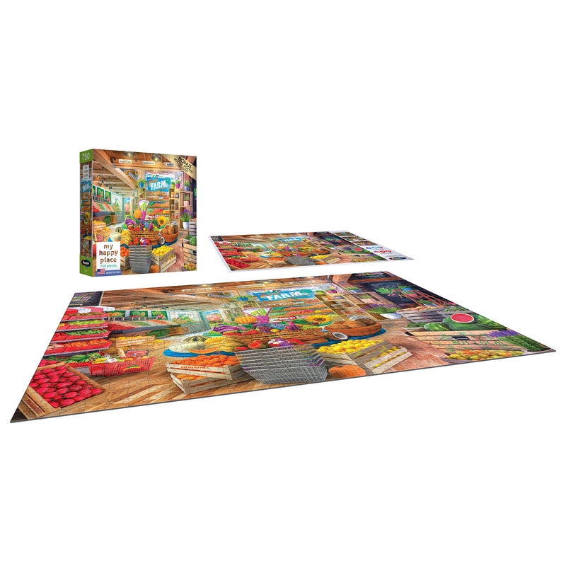 A completed jigsaw puzzle depicting a busy market scene is shown next to its box. The box also displays the same market scene from the RoseArt - My Happy Place - Organic Fresh Market - 750 Piece Jigsaw Puzzle.
