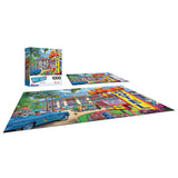 A 1000-piece puzzle featuring a vibrant, retro motel scene with classic cars and lush greenery. The completed puzzle is displayed next to its box. RoseArt - Back to the Past - Rose Motel - 1000 Piece Jigsaw Puzzle.