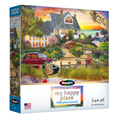 A 1000-piece puzzle box featuring a colorful seaside house and garden scene titled "RoseArt - My Happy Place - Seaside Hill - 1000 piece jigsaw puzzle" by David Maclean, with a bonus puzzle poster included.