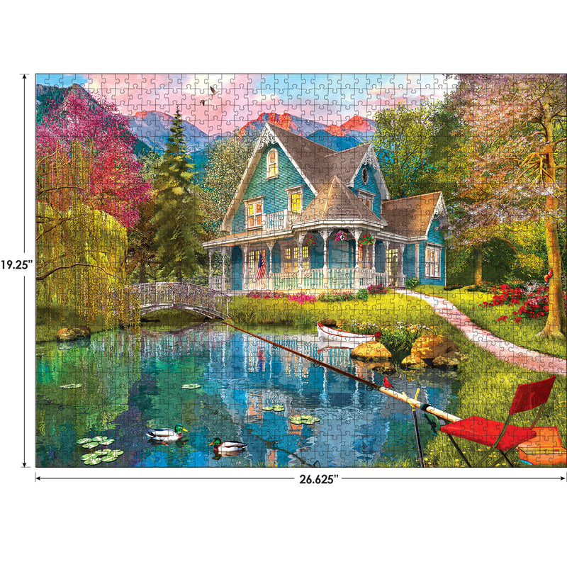 A completed RoseArt - My Happy Place - Fishing Retreat - 1000 Piece Jigsaw Puzzle depicting a serene lakeside scene with a house, pond with ducks, a fishing rod, a red chair, and a bridge.