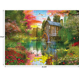 Completed RoseArt - My Happy Place - Sunset at the Mill - 1000 Piece Jigsaw Puzzle of a serene mill by a river surrounded by colorful flowers and trees, with vivid sunset skies. Measurements indicate 26.625 inches by 19.25 inches.