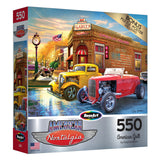 A 500-piece puzzle box featuring a vintage American diner scene with classic cars, titled "RoseArt - American Nostalgia - American Grill," from RoseArt. Bonus poster included.