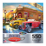 Puzzle box cover featuring classic cars parked in front of a nostalgic American diner with a sign reading "Clancy's" under a sunset sky. The puzzle has 550 pieces and is titled "RoseArt - American Nostalgia - American Grill - 500 Piece Jigsaw Puzzle.