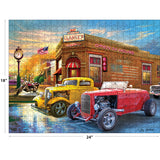 A completed RoseArt - American Nostalgia - American Grill - 500 Piece Jigsaw Puzzle depicting classic cars and a motorcycle parked in front of a diner, with the dimensions noted as 18 inches by 24 inches.