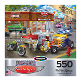 Puzzle box featuring vintage cars, motorcycles, and a gas station scene. Text reads: "RoseArt - American Nostalgia - Hot Rod Garage - 550 Piece Jigsaw Puzzle - Bonus puzzle poster included.