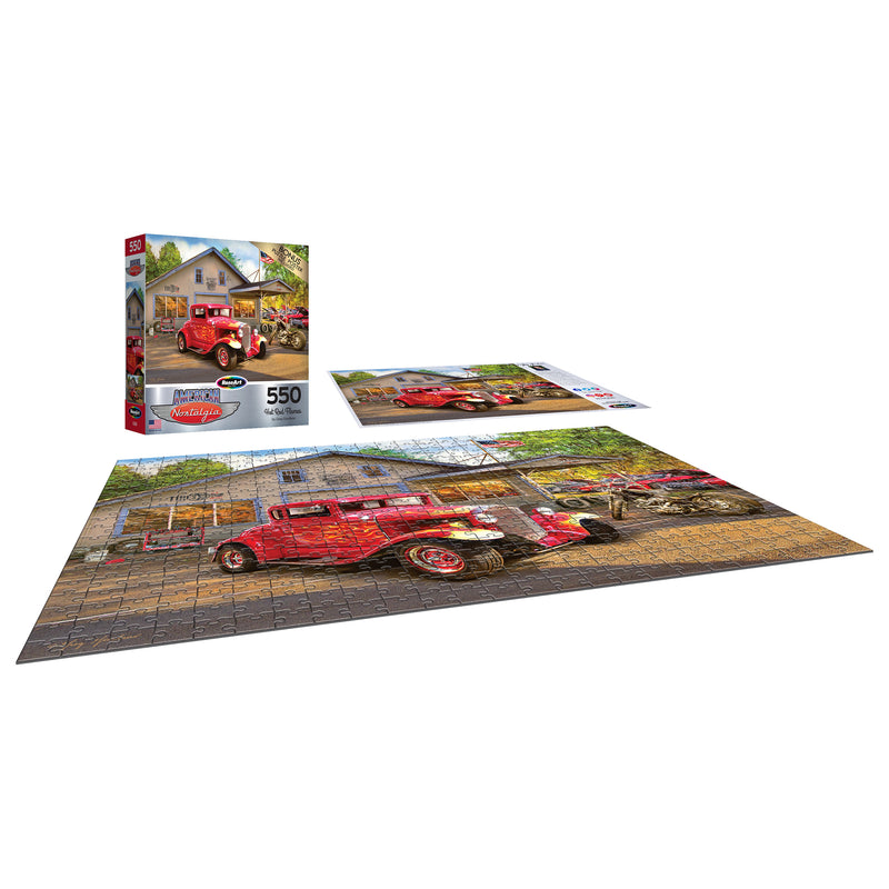 A completed RoseArt - American Nostalgia - Hot Rod Flames - 550 Piece Jigsaw Puzzle featuring a red vintage car in front of a house. The puzzle box and another incomplete section are shown next to it.