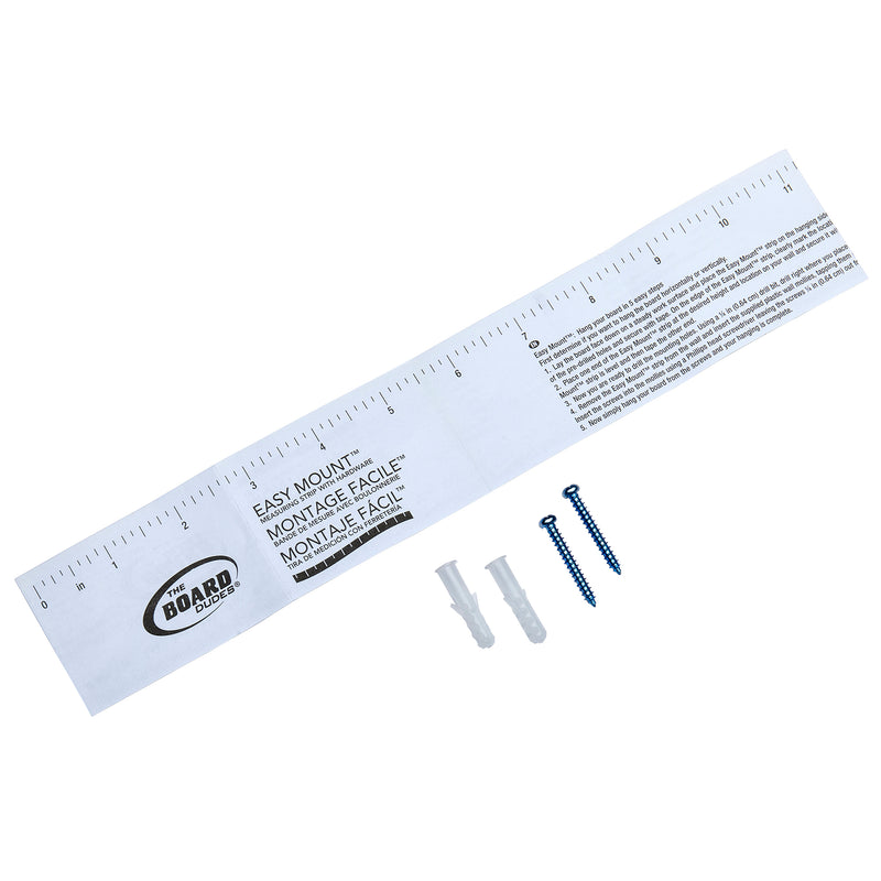 A white paper measuring guide labeled "Board Dudes Chalk Board - Wood Frame 35x23 INCH" lies next to two plastic wall anchors and two screws, used for mounting objects on walls.