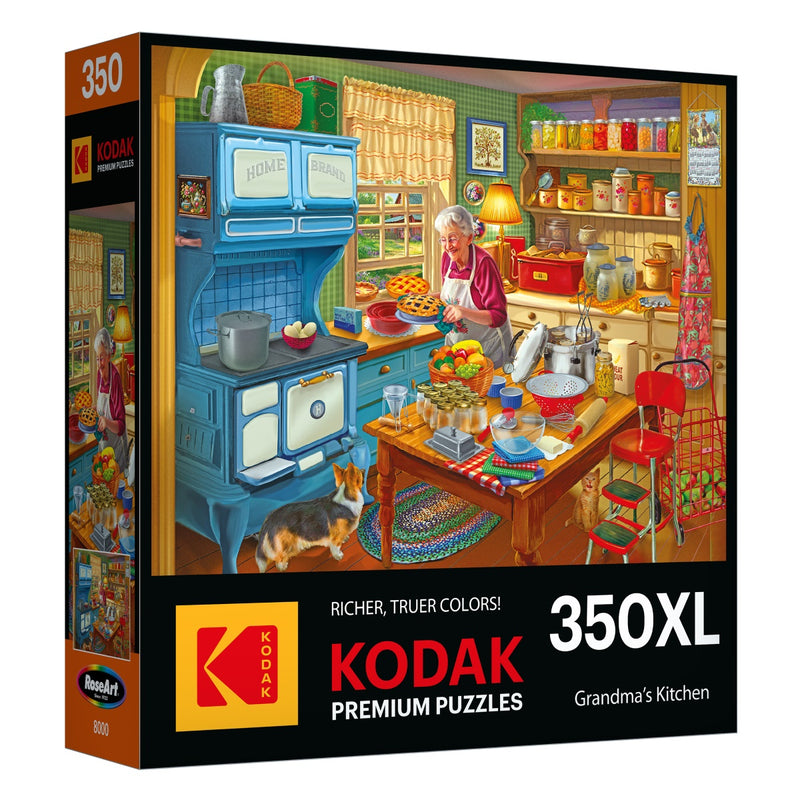 A 350-piece RoseArt - KODAK Premium - Grandma's Kitchen - 350 Piece Jigsaw Puzzle box showing an illustration of a colorful kitchen scene with an elderly woman baking, a dog nearby, and various cooking tools and ingredients around. Brand name and title included.
