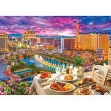 A RoseArt - Kodak Premium - La Vida Las Vegas - 3000 Piece Jigsaw Puzzle with various dishes and drinks overlooks a Las Vegas skyline at sunset, featuring hotels, casinos, and landmarks such as the Eiffel Tower replica and a Ferris wheel.