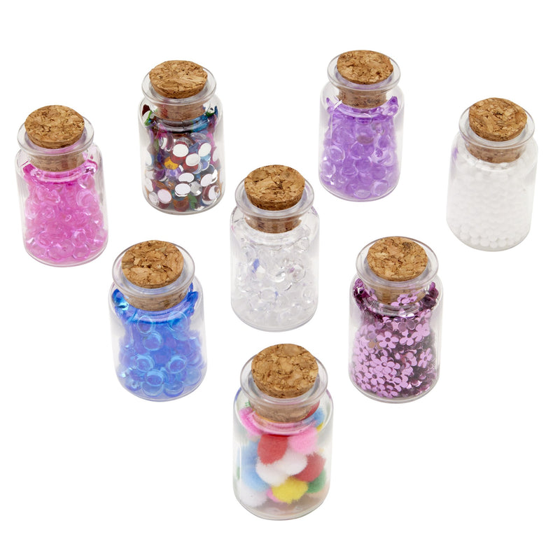 Cra-Z-Slimy Beads & Beyond 8-jar slime mix-in set out of box with jars of colorful beads, gems, flower sequins, foam balls, and mini pom poms for slime and crafts.