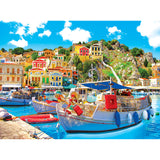 A picturesque harbor with colorful buildings on a hillside, boats docked in blue water, and a clear, sunny sky above can be found in the RoseArt - Kodak Premium - Symi with Boats in the Harbor, Greece - 1000 Piece Jigsaw Puzzle.